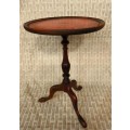 A stunning Victorian antique mahogany occasional table w/ a leather clad top and scalloped rim