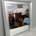 An awesome silver gilded "bevelled" wall mirror with a broad solid wooden frame in great condition