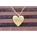A beautiful gold plated ladies necklace with a large "heart" shape pendant