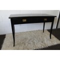 A lovely stained black writing desk with two spacious drawers in remarkable condition