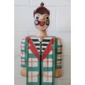 An interesting and unusual free standing antique tabletop cabinet in the form of a clown w/ shelves