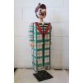 An interesting and unusual free standing antique tabletop cabinet in the form of a clown w/ shelves