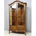 A magnificent solid Stinkwood "gabled" display cabinet with cutlery drawers & glass display shelves