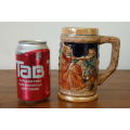 An amazing vintage German made stoneware beer tankard w/ traditional hand glazed detailing