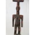 An exquisite and unusual "tall" hand carved wooden african tribal art figurine