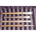 An incredible set of four vintage sculpting tools with wooden handles, brass cuffs & celluloid tips