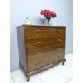 An exquisite vintage Oak 4-drawer chest of drawers with ornate handles and ample storage space