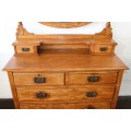 A magnificent antique solid oak dressing table w/ 6 drawers & a large beveled mirror on castors