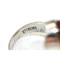A magnificent sterling silver stamped mid-century "modernist" ring w/ huge amber centre stone