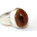A magnificent sterling silver stamped mid-century "modernist" ring w/ huge amber centre stone