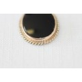 A magnificent 9ct gold pendant with large Onyx stone and amazing braiding around the edges