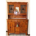 A great antique Oregon buffet server w/ three drawers & four cupboards, two with stained glass doors