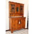 A great antique Oregon buffet server w/ three drawers & four cupboards, two with stained glass doors