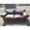 A stunning x-large modern styled brown genuine leather couch in great condition. RS17
