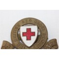 An awesome enamelled "The British Red Cross Society" cap badge