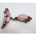 A stunning vintage gold plated ladies brooch with purple diamante and simulated Opal stones