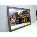 A fantastic large wall mirror w/ a fabulous wooden frame. Perfect in a large room.