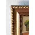 An amazing oil painting of a landscape framed in a lovely moulded frame