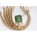 A beautiful vintage gold plated ladies brooch with a large square green Zirconia stone