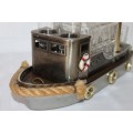 An amazing vintage tugboat decanter with a wind-up music box and four shot glasses