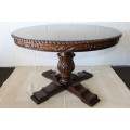 A very well made and heavy oak dining table w/ a wonderfully carved centre leg