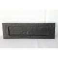 A cast iron mail slot that would look great in a larger door in very good condition