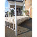 A beautiful, dainty and elegant wrought iron single bed and mattress, perfect for a girls bedroom.