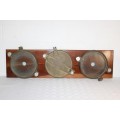 A superb antique (XL) solid cast brass double-hinged porthole with a storm cover mounted on teak