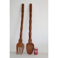 A wonderful very large African hand carved spoon and fork with beautiful elephant carvings on it