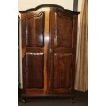 A stunning gabled double-door solid Imbuia ball & claw wardrobe w/ solid brass embellishments