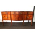 A magnificent Kingswood finished Regency buffet/ side server with spade feet and a curved front