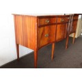 A magnificent Kingswood finished Regency buffet/ side server with spade feet and a curved front