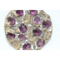 A stunning large vintage round gold-tone ladies floral brooch with an array of Amethyst stones