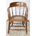 A magnificent Edwardian antique solid oak tub chair with a wicker bottom - very collectable!