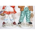 Two lovely ceramic figurines of a boy and a girl with hand painted detailing
