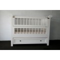 A stunning white babies crib bed/ cot w/ brass safety latches, fold-down side & large storage drawer
