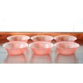 A wonderful set of six pink-glass bowls with a gorgeous raised "grape" pattern detailing