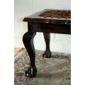 A stunning and well-made vintage solid imbuia ball & claw riempie foot stool with leather riempies