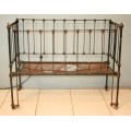 A stunning & rare antique (late 1800's) wrought iron baby's cot w/ dropside on its original castors
