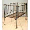 A stunning & rare antique (late 1800's) wrought iron baby's cot w/ dropside on its original castors