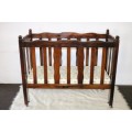 An awesome vintage solid Imbuia baby's cot w/ dropside on its original castors - perfect for nursery