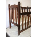 An awesome vintage solid Imbuia baby's cot w/ dropside on its original castors - perfect for nursery