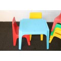 A set of 7x kids multi-coloured plastic chairs & a blue kids table; perfect for kids play room