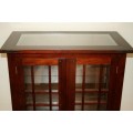 An incredibly well made solid Indonesian teak cabinet with glass shelves and beautiful slatted doors