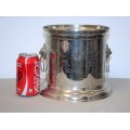 A stunning silver plated wine cooler with beautiful engraved detailing and lion-head ring handles