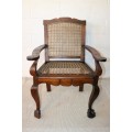 A lovely rattan-back and seat arm chair with ball and claw feet & cabriole legs - great for a patio!