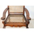 A lovely rattan-back and seat arm chair with ball and claw feet & cabriole legs - great for a patio!