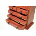 An awesome hand made solid teak jewellery box with six drawers and a storage tray under the lid