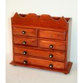 A gorgeous hand made solid teak jewellery box with six drawers and a storage section on top