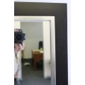 A stylish modern dark wood rectangular wall mirror with brushed steel detailing -  RS17M